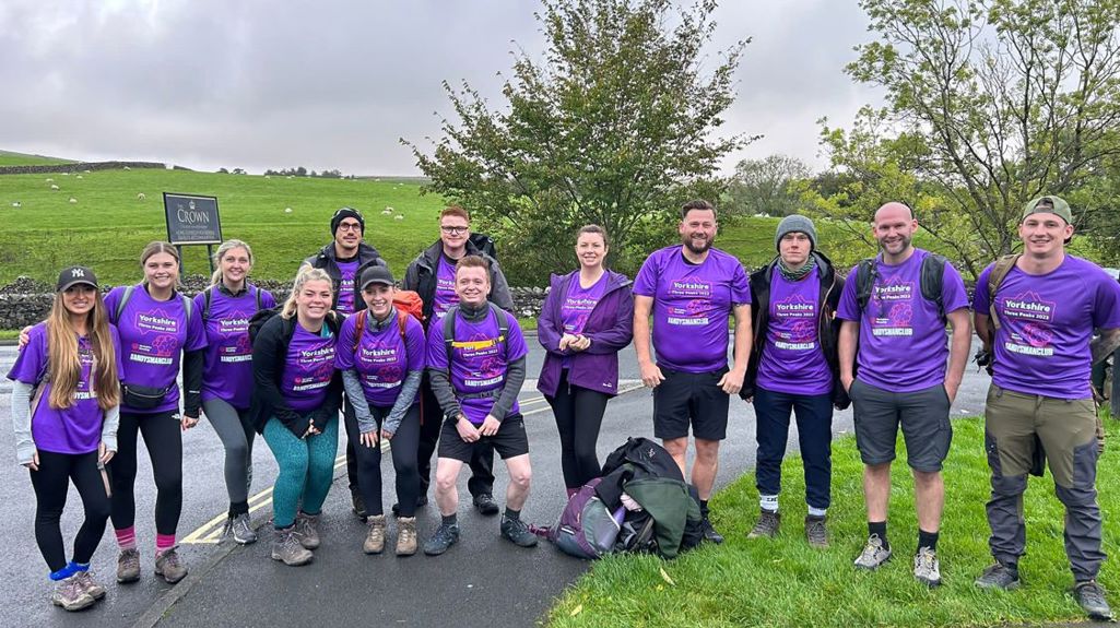 A group photo of 13 Yorkshire Housing colleagues about to take on Yorkshire 3 Peaks