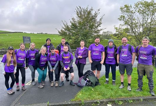 A group photo of 13 Yorkshire Housing colleagues about to take on Yorkshire 3 Peaks