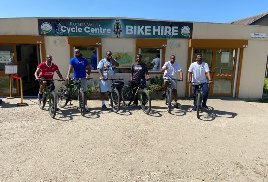 A photograph of five cyclists ready to set off on their bike ride in Somali. 