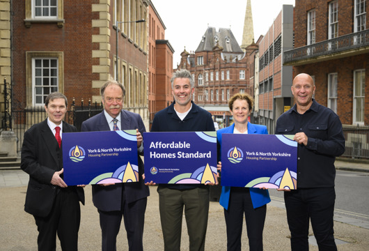 Pictured in York City Centre holding graphic boards is Councillor Michael Pavlovic, Executive Member for Housing, Planning and Safer Communities at City of York Council, Councillor Simon Myers, Executive Member for Culture, Arts and Housing at North Yorkshire Council, David Skaith, Mayor of York and North Yorkshire, Councillor Claire Douglas, Leader of City of York Council, and Nick Atkin, Chair of the York and North Yorkshire Housing Partnership