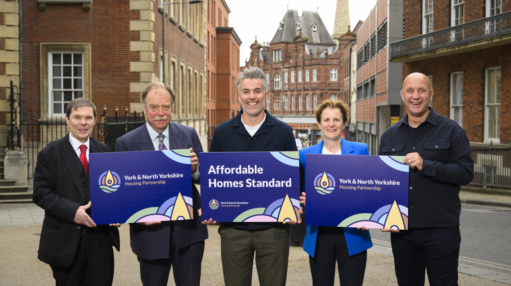 Pictured in York City Centre holding graphic boards is Councillor Michael Pavlovic, Executive Member for Housing, Planning and Safer Communities at City of York Council, Councillor Simon Myers, Executive Member for Culture, Arts and Housing at North Yorkshire Council, David Skaith, Mayor of York and North Yorkshire, Councillor Claire Douglas, Leader of City of York Council, and Nick Atkin, Chair of the York and North Yorkshire Housing Partnership