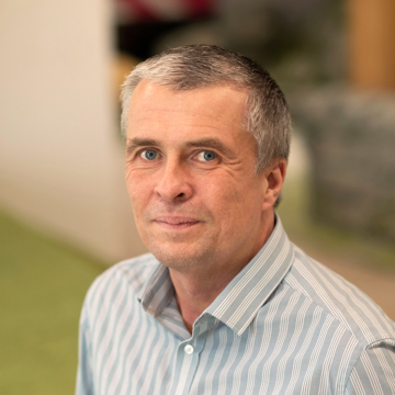 Man smiling at camera in office environment 