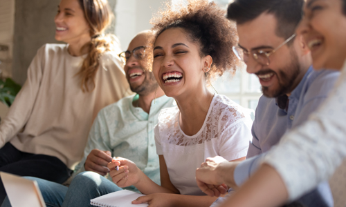 Group of five people laughing