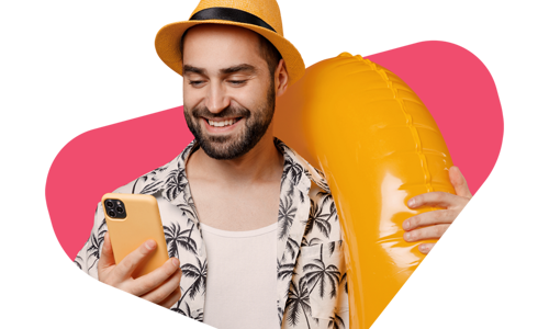 Man wearing a palm tree smiling at his phone 