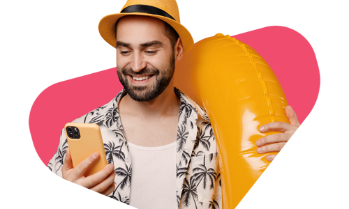 Man wearing a palm tree smiling at his phone