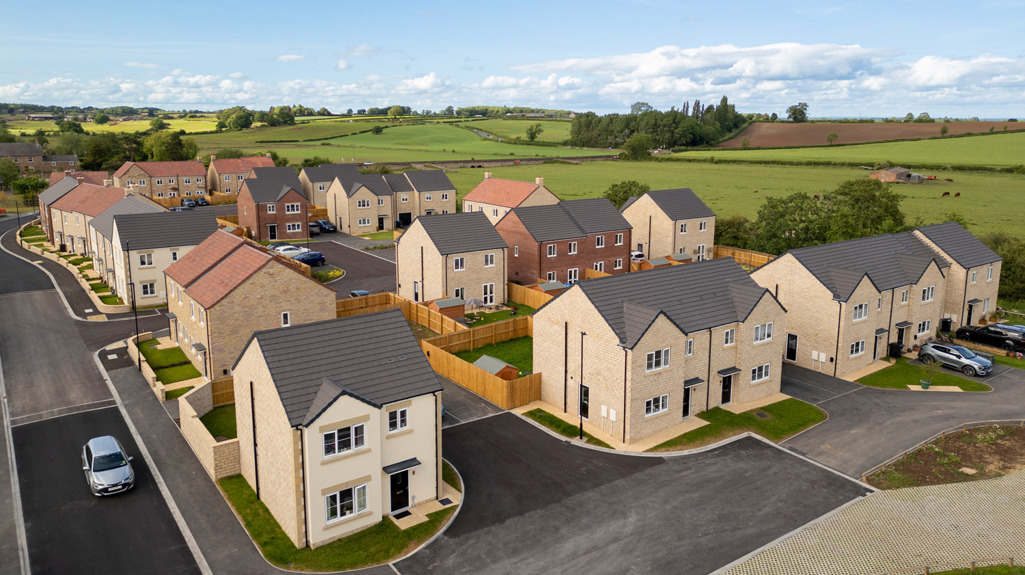 A drone image of affordable homes at the Bridgewell development in Spofforth with blue skies and countryside in the background.