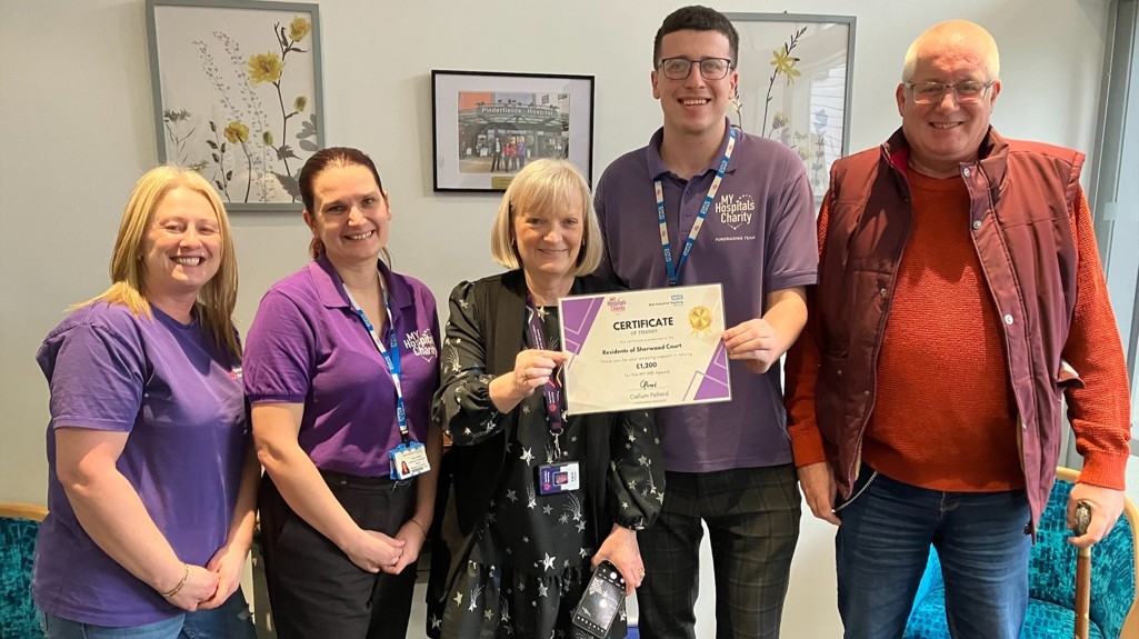 Yorkshire Housing customers at Sherwood Court being presented with a certificate of thanks from Pinderfields Hospital staff.