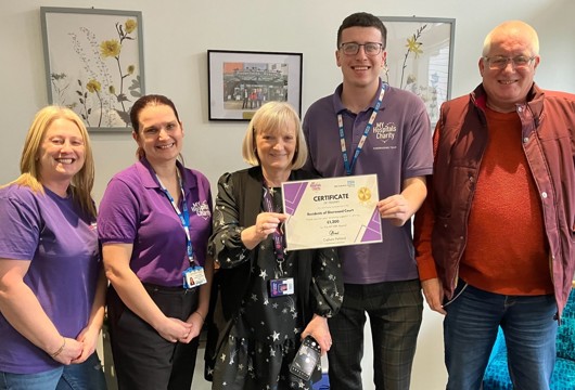 Yorkshire Housing customers at Sherwood Court being presented with a certificate of thanks from Pinderfields Hospital staff.