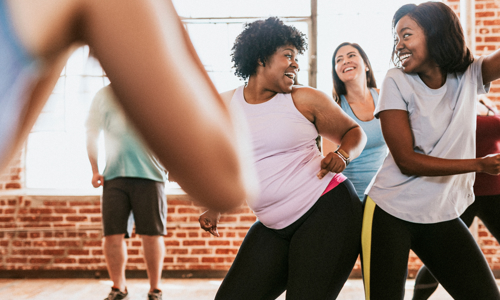 two cheerful active ladies during a dance aerobics class