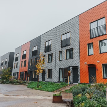 A row of multi-coloured terraced homes at the Climate Innovation District in Leeds.