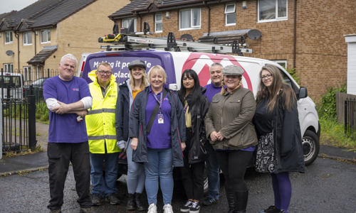 A group photo of some of our colleagues stood infront of one of our vans from our Big Day Out