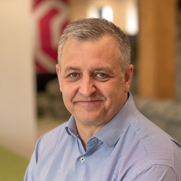 Man smiling at camera in office environment 