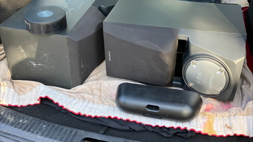 Audio equipment including two large speakers in the open boot of a car