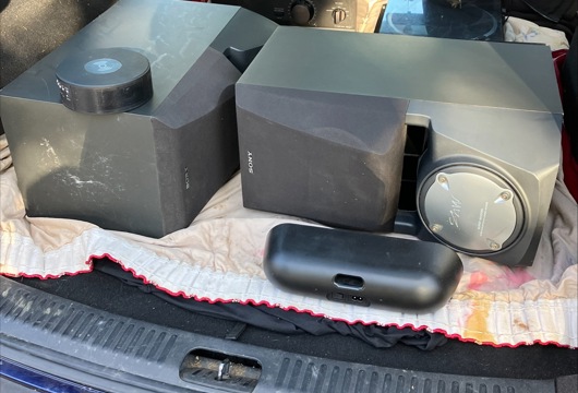 Audio equipment including two large speakers in the open boot of a car