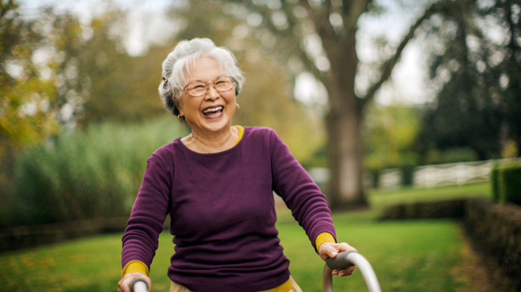 Smiling older woman with walking frame