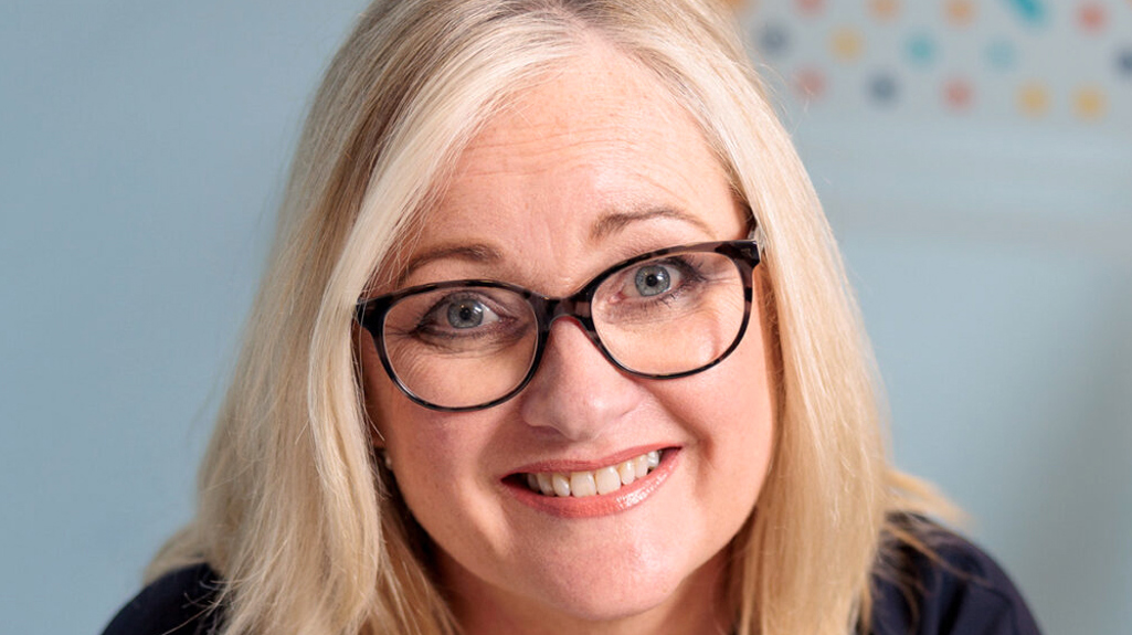 Woman smiling at camera in office environment 