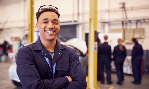 Happy apprentice in a workshop environment