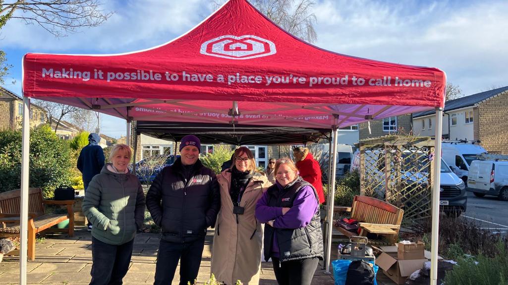 Yorkshire Housing colleagues standing under a red Yorkshire Housing canopy at Allen Croft during a customer event