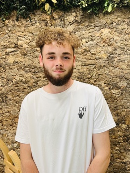 Photo of Charlie our gas apprentice stood in front of a cork wall