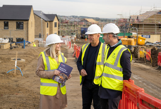 Tracy Brabin on site talking to Nick Atkin and someone from Homes England, they're all wearing hard hats and hi vis jackets