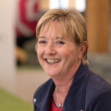 Woman smiling at camera in office environment 