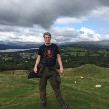 Man standing on top of hill in Lake District