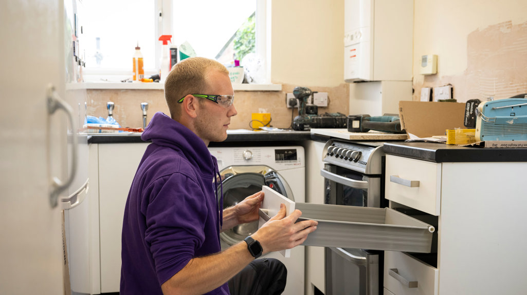 Yorkshire Housing colleague carrying out installation work in a kitchen