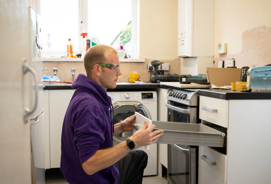 Yorkshire Housing colleague carrying out installation work in a kitchen