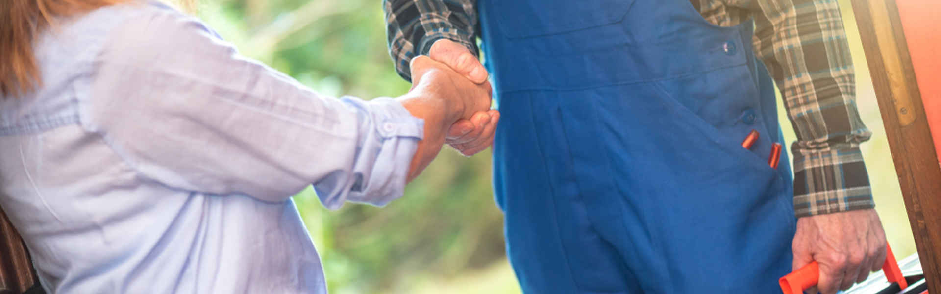 Woman shaking hand with repair man