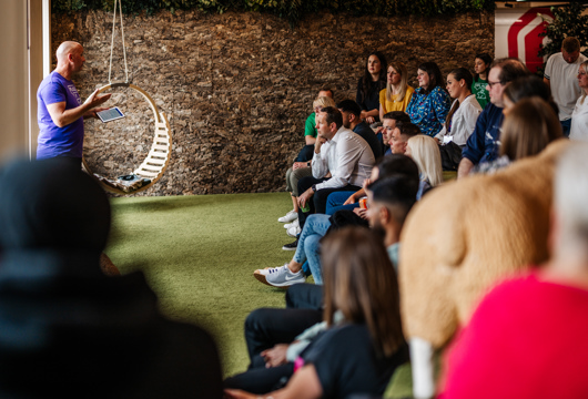 Group of people being presented to in an indoor park