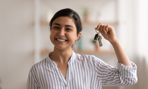 Woman smiling with bunch of keys