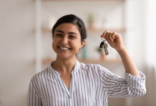 Woman smiling with bunch of keys