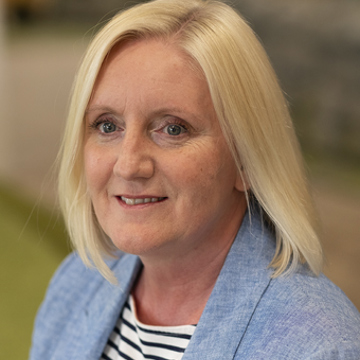 Woman smiling at camera in office environment 