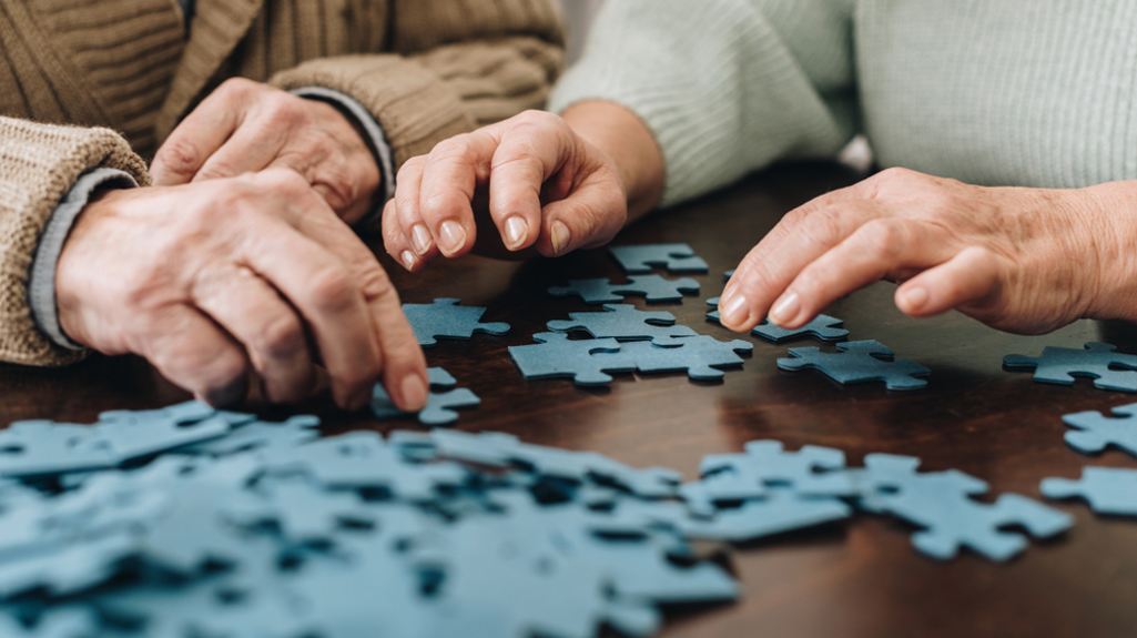 Two people sitting at table sorting out jigsaw puzzle pieces