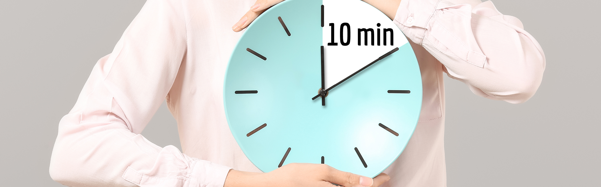 A woman holding a clock that shows 10 minutes countdown 