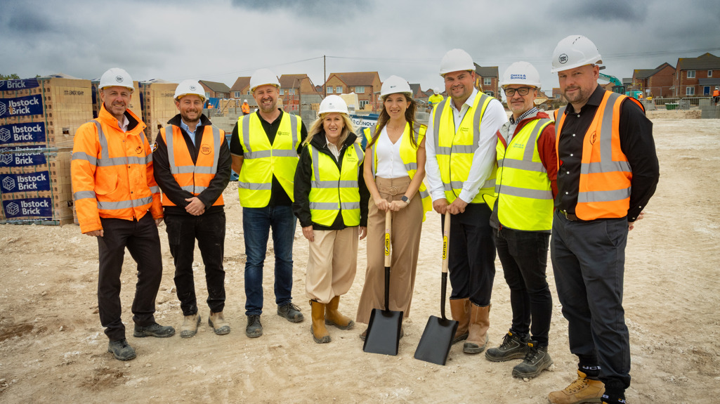 The project team, including colleagues from Yorkshire Housing, Esh Construction, Drees & Sommer, and Homes England, wearing PPE and stood in a group at the Pinfold Lane site.