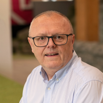 Man smiling at camera in office environment 