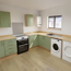 Image of a green kitchen with wood effect worktops