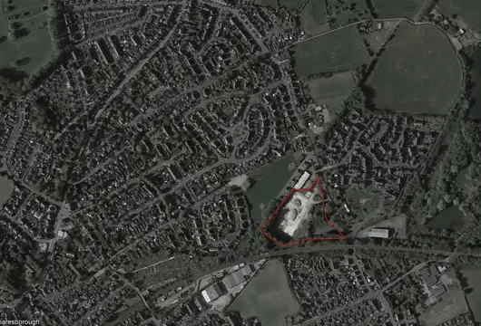 Aerial view showing an area for development of new homes outlined in red