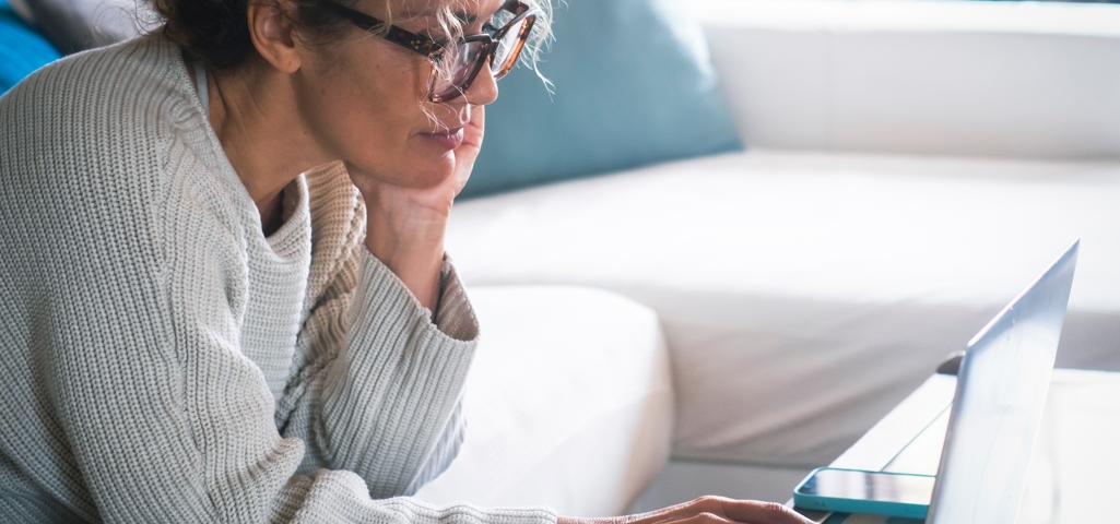 Woman looking on a laptop at home