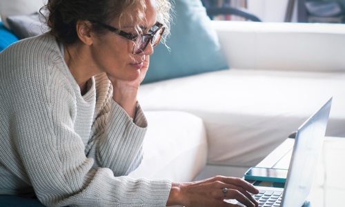 Woman looking on a laptop at home