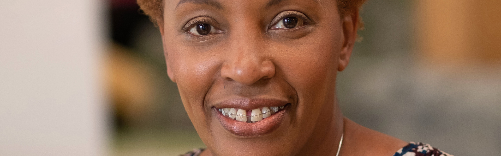 Woman smiling at camera in office environment 