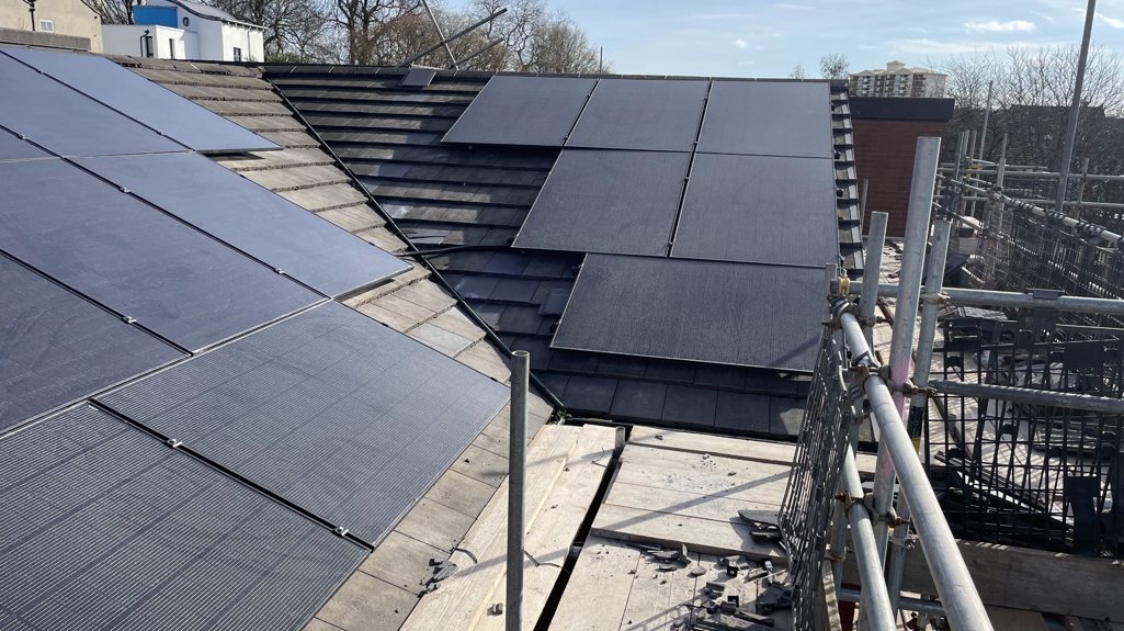 A photo of solar panels on a roof