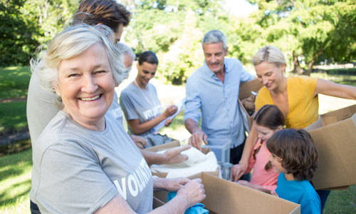 A photo of a group of people with some cardboard boxes.